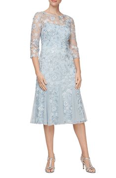 Get the glasses raised in honor of your elegant entrance in this ice-blue cocktail dress tumbled with tonal blooms and styled with soft godet pleats. Ballet neck Three-quarter sleeves 100% polyester Hand wash, line dry Imported Blue Tea Length Dress, Wedding Dresses For Older Women, Soft Blue Dress, Elegant Entrance, Fit And Flare Cocktail Dress, Evening Midi Dress, Embroidered Midi Dress, Alex Evenings, Blue Cocktail Dress