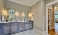 a large bathroom with double sinks and mirrors