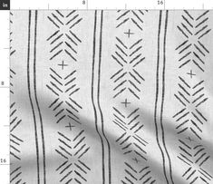 a blue and white fabric with small black lines on the side, in front of a ruler