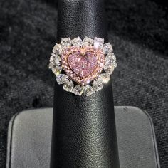 Approximately 1.00 Carat Heart Shape GIA Certified Faint Pink 3.00 Carat Total VVS1 Clarity Set in 18k White Gold Fancy Pink Diamond Halo 16 White Pear Shapes Order will be ready to ship in 3-4 weeks. Luxury Rose Cut Diamond Heart Ring For Anniversary, Luxury Rose Gold Diamond Ring For Valentine's Day, Luxury Heart Cut Gia Certified Rings, Heart Cut Moissanite Diamond Ring For Proposal, Moissanite Heart Cut Diamond Ring For Proposal, Luxury Heart-shaped Diamond Ring, Luxury Heart Cut Cubic Zirconia Wedding Ring, Luxury Jewelry For Valentine's Day Proposal, Luxury Valentine's Day Proposal Jewelry