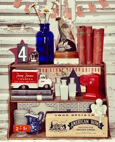 an assortment of items displayed on a shelf in front of a wooden wall with american flag decorations