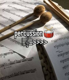 some music notes and two drums on top of each other with the words percussion above them