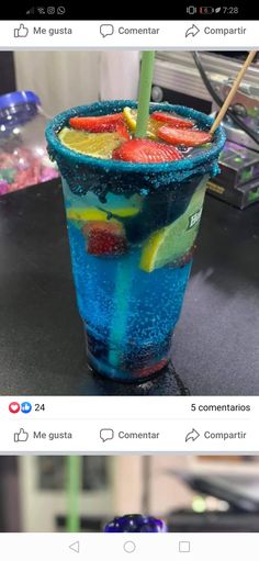 a blue drink with strawberries and lemons in it