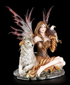 a statue of a woman sitting next to a wolf and holding a bird on her arm