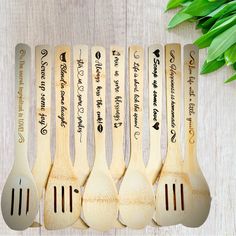 six wooden spoons with writing on them