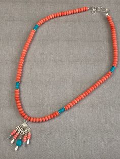 "Love the Southwest? Love Salmon pink and Turquoise together? This necklace satisfies both! Lovely, smooth Salmon pink Coral beads adorn this necklace with accents of small Sleeping Beauty Turquoise beads. These colors are so perfect together and utterly speak \"Southwest\"!. The central pendant is a fan of Sterling silver with coral beads and a stunning nugget of Sleeping Beauty Turquoise which is a rare and coveted type of Turquoise. Perfect for a collector! The necklace measures 20-inches wit Spinel Jewelry, Coral Beads Necklace, Pendant Necklace Simple, Turquoise Pendant Necklace, Perfect Together, Southwest Jewelry, Beaded Jewelry Designs, Coral Jewelry, Sleeping Beauty Turquoise