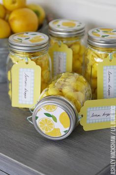 jars filled with lemons sitting on top of a table