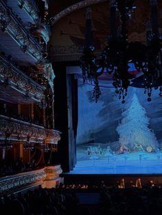 the stage is decorated with chandeliers and lights for an animated christmas tree show