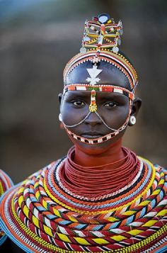 an african woman with painted face and headdress