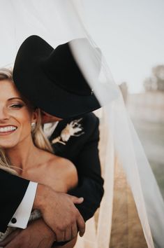 a man in a cowboy hat hugging a woman