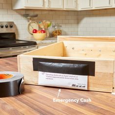 an emergency cash box is on the counter next to a tape dispenser