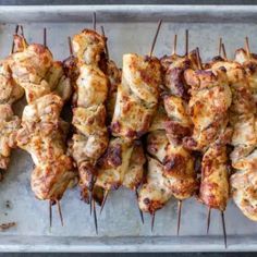 chicken skewers on a baking sheet ready to be grilled and served for consumption