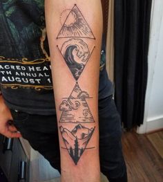 a person with a tattoo on their arm that has mountains and waves in the sky