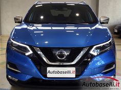 the front end of a blue nissan suv