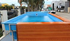 an above ground swimming pool with wooden boards