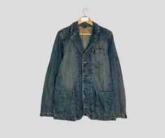 Vintage Rare LEVI STRAUSS Denim Chore Jacket Vintage Levi Strauss French Workwear Jean Jacket Levi Strauss Workers Full Button Jacket Unisex CONDITION :- ✅GOODUSED CONDITION. ✅NO STAINS  ✅NO HOLE ITEM DESCRIPTION:- ✅SIZE: L ✅MATERIAL : DENIM ✅THIS USED & VINTAGE ITEMS, SO DON'T EXPECTED IT TO BE LIKE NEW CONDITION!! MEASUREMENT:- ✅ARMPIT TO ARMPIT : 20 INCH ✅LENGTH BACK COLOR/NECK TO HEM : 30 INCH ✅SHOULDER : 16 INCI  ✅SLEEVE LENGTH: 26 INCH PLEASE REFER PHOTO BEFORE ORDER ALL MEASUREMENTS ARE T Casual Medium Wash Blazer With Buttons, Denim Jacket With Lapel Collar And Buttons For Work, Lapel Collar Denim Jacket With Buttons For Work, Denim Jacket With Lapel Collar For Work, Medium Wash Long Sleeve Blazer With Pockets, Utility Style Dark Wash Denim Jacket With Buttons, Dark Wash Utility Denim Jacket With Buttons, Denim Blazer With Pockets And Lapel Collar, Casual Dark Wash Blazer With Button Closure