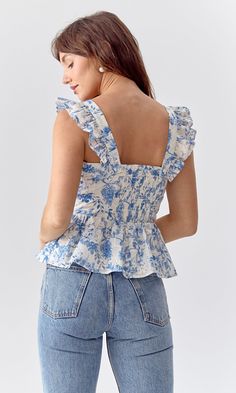 Embroidered peplum top with ruffled sleeves. The square neckpiece is defined by it's light blue, floral print. Ruffled sleeves Floral pring Self: 80% Polyester 20% Cotton Lining: 100% Cotton Length: 21" Chest: 16" Hand wash in cold water. Lay flat to dry. Low iron. Model is wearing a size small Style #: G244T7010 Ropa Upcycling, Blue Floral Top, Future Wardrobe, Tops And Blouses, Senior Picture Outfits, Sweater Jumpsuit, Soft Floral, Blue Floral Print, Ruffled Sleeves