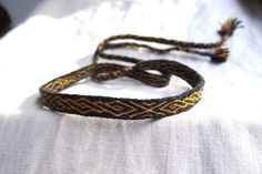 I'd like to present a woolen tablet woven headband which will make a great addition to a viking or medieval costume. It features a very popular medieval decorative motif. This headband will also be perfect for LARP or as a hatband. The product is made to order. The woven part takes about 50 cm / 19,5", the braided ends are about 30 cm long each. The headband is 1,3 cm wide and made from wool in dark grey and yellow. Please note that due to different color adjustment of your and my screens the co Brown Adjustable Handmade Headband, Medieval Tablet Weaving, Woven Headband, Card Weaving, Tablet Weaving, Braids With Weave, Medieval Costume, Hat Band, Adult Costumes