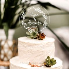 a wedding cake with succulents on top and the name rona hexandra