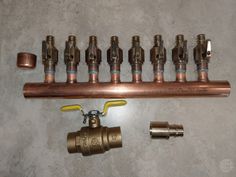 there are many different types of valves and fittings on the wall next to each other