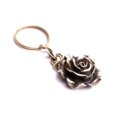 a rose shaped metal keychain on a white background