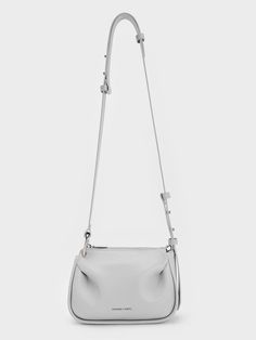 This product is made with at least 20% sustainable materials by weight. CHARLES & KEITH uses recycled, degradable, organic, and water-based materials in our eco-conscious collection. With its hands-free functionality and charming tactility, the Lumen crossbody will become an instant favourite. Padded folds add distinctive flair to the minimalist grey exterior -- the rest of the silhouette is kept clean and unembellished. Equipped with an adjustable strap, you can style it in various ways. Pair it with your go-to neutrals to put a fun twist on the classic look. Grey Exterior, Charles Keith, Eco Conscious, Sustainable Materials, Kids Gifts, Bag Straps, Hands Free, Sales Gifts, Keep It Cleaner