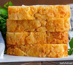 four pieces of bread stacked on top of each other with parsley in the background