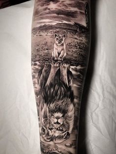 a man's leg with an animal and lion tattoo on the side of it