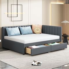 a modern daybed with storage underneath it in a living room or dining room area