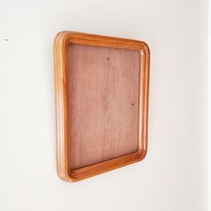 a wooden frame hanging on the wall