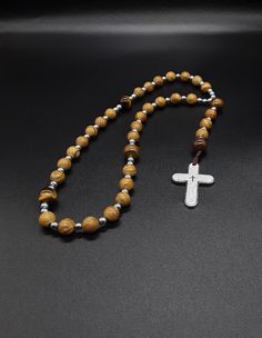 "The Anglican Rosary called \"our Holy Father\" is a beautiful rosary that is based on the heavenly golden colors which radiate a soothing effect while praying. The rosary is made of Jasper, Tigers Eye and Hematite gemstones (which have been cleansed and purified), 304 Stainless Silver Cross with the Lord's Prayer engraved on it. Finally, the rosary has been blessed by the church. Rosary: Anglican configuration Blessed: Yes About the Rosary: The Rosary has a Cross, an Invitatory bead, 4 sets of Spiritual Crucifix Necklace With 8mm Beads, 108 Beads Cross Rosary For Meditation, Spiritual Rosary With Polished Beads As Gift, Gift Rosary With Polished Beads And Cross, Gift Rosary With Polished Beads, Adjustable Spiritual Rosary With Cross Pendant, Anglican Rosary, St Benedict Cross, Beautiful Rosary