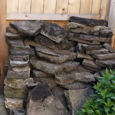 a pile of rocks sitting next to a wooden fence