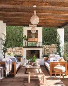 an outdoor living area with couches and tables