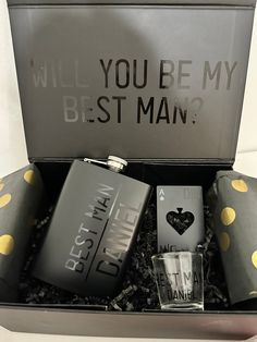 a gift box with four flasks, two shot glasses and one card case