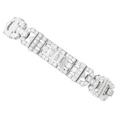 A magnificent, fine and impressive, rare antique 11.75 carat diamond and platinum Art Deco bracelet; part of our diverse antique 1920s diamond jewellery collections. This magnificent, fine and impressive antique diamond bracelet has been crafted in platinum. The articulated bracelet is composed of three elongated, articulated pierced decorated Art Deco settings, alternating with rectangular cut-cornered links and horizontal pales. Each elongated setting is embellished with a stunning central col Platinum Bracelet, Art Deco Bracelet, Transitional Modern, Luxury Diamonds, Estilo Art Deco, Art Deco Diamond, Antique Diamond, Baguette Cut, Antique Art Deco