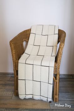 a chair with a white and black blanket on it