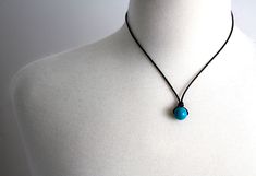 Simply stoned minimalist Turquoise necklace on choice of Black Leather or Black Waxed Cotton cord and sterling silver clasp. The perfect size for a little pop of turquoise color. With its unisex styling, this choker would be perfect for a child, teen or adult. Gemstone Focal Bead: Turquoise, approx. 12mm FINDINGS: Sterling silver clasp at back CORD MATERIAL: Pictured on Black Leather. Also available on Black Waxed Cotton. If you are going to wear this 24/7 I recommend the Black Waxed Cotton as i Boys Necklace, Peace Sign Necklace, Car Charms Mirror, Gemstone Choker, Necklace Mens, Turquoise Pendant Necklace, Mens Necklace, Jewelry Simple, Necklace Gemstone