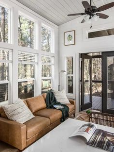 a living room filled with furniture and lots of windows