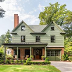 a large green house sitting in the middle of a lush green field