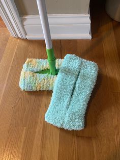 the mop is laying on the floor next to two towels