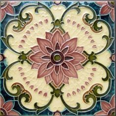 a decorative tile with a pink flower on it