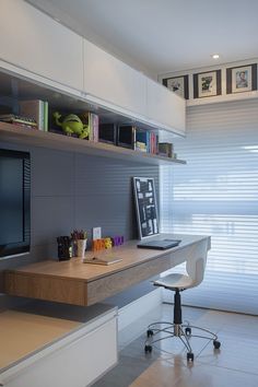 a desk with a monitor, keyboard and other items on it