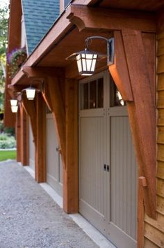 an outside view of a house with lights on the front door and side walk leading up to it