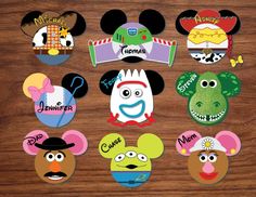 mickey mouse and friends cut outs are on a wooden surface, with the faces of each character