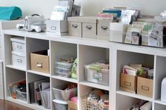 the shelves are filled with many different types of boxes and bins on top of them