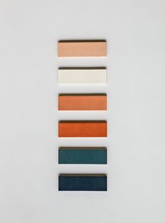 five different shades of paint on a white surface with one color swatch in the middle