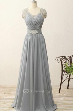 a gray bridesmaid dress on a mannequin stand in front of a chair