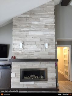 a living room with a fireplace and tv mounted on the wall next to an oven