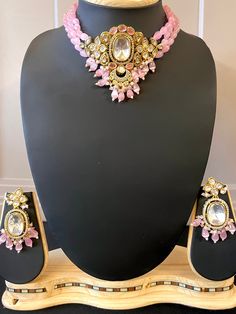 Premium Quality Polki Chokar Style Necklace with Monalisa Beads with a Sliver Foiled Middle Stone. Light Weight and easy to wear for long hours. Item : Necklace with earring Color : Gold Polish, Baby Pink Beads and White Stone Length of the Beads including centerpiece - 8 1/2 inches (The length does not include the adjustment tie) Length of Centerpiece : 3 inches Width of Centerpiece : 2.3inches Length of Earrings : 2.1 inches Width of Earnings - 1 inches Shop Polices -- Final Sale, No Return, N Men's Ethnic Wear, Tie Length, Readymade Blouse, Long Hours, Pink Beads, Gold Polish, Buy Handmade, Style Necklace, White Stone