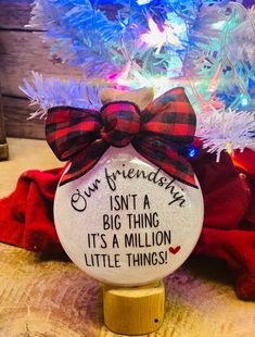 a glass ornament with a red bow on it and the words, our friends isn't a big thing its a million little things